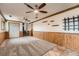 Finished basement with carpet, wood paneling, built in storage, and access to stairs at 1824 S Granby St, Aurora, CO 80012
