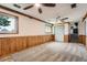 Finished basement showcasing carpet, wood paneling, bright windows, and closet space at 1824 S Granby St, Aurora, CO 80012