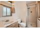 Bathroom featuring single sink vanity, toilet and standing shower with glass door at 1824 S Granby St, Aurora, CO 80012