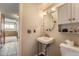 Powder room with pedestal sink, decorative mirror and lighting fixture at 1824 S Granby St, Aurora, CO 80012