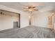 Spacious bedroom featuring a ceiling fan, closet, plush carpeting and access to a private bathroom at 1824 S Granby St, Aurora, CO 80012