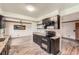Well-appointed kitchen with a double oven, granite counters, and black appliances at 1824 S Granby St, Aurora, CO 80012