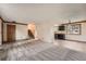 Open-concept living space with new flooring, stairs to the upper level, and a kitchen view at 1824 S Granby St, Aurora, CO 80012