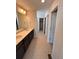 Bathroom featuring double sinks, neutral paint, and a tile floor at 393 Grey Rock St, Brighton, CO 80601