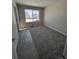 Bedroom with neutral colors and large window providing natural light at 393 Grey Rock St, Brighton, CO 80601