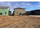 Rear view of new construction home with unfinished landscaping at 393 Grey Rock St, Brighton, CO 80601