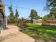 Backyard features a lawn, a stone patio, flowerbeds, a fence, and a storage shed at 3750 S Galapago St, Englewood, CO 80110
