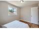 Comfortable bedroom with hardwood floors, a large window, and a closet for storage at 3750 S Galapago St, Englewood, CO 80110