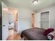 A bedroom with hardwood floors, a walk-in closet, and an attached laundry room at 3750 S Galapago St, Englewood, CO 80110