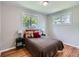 Bright bedroom featuring hardwood floors, two windows, and modern décor at 3750 S Galapago St, Englewood, CO 80110