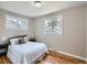 Serene bedroom featuring hardwood floors, neutral décor, and plenty of natural light at 3750 S Galapago St, Englewood, CO 80110