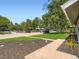 Landscaped front yard with a lush lawn, plantings, a sidewalk, and a view of the street with cars at 3750 S Galapago St, Englewood, CO 80110