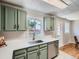 Well-appointed kitchen featuring updated countertops, stainless steel appliances, and charming green cabinets at 3750 S Galapago St, Englewood, CO 80110