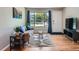 This living room showcases a bright view from the large window, hardwood floors, and stylish furnishings at 3750 S Galapago St, Englewood, CO 80110