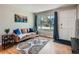 Comfortable living room featuring hardwood floors and abundant natural light from a large window at 3750 S Galapago St, Englewood, CO 80110