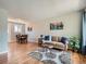 Inviting living room boasts hardwood floors, cozy seating, and an adjacent dining area at 3750 S Galapago St, Englewood, CO 80110
