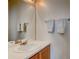 Clean bathroom featuring a single sink vanity, large mirror, and towel racks at 4120 E 119Th Pl # B, Thornton, CO 80233