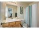 Bathroom featuring a toilet, shower with patterned curtain, and a vanity with mirror at 4120 E 119Th Pl # B, Thornton, CO 80233