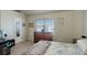 Bright bedroom featuring a large window and a tall dresser at 4120 E 119Th Pl # B, Thornton, CO 80233
