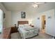 Inviting bedroom with a ceiling fan, two matching wood night stands and en suite bathroom at 4120 E 119Th Pl # B, Thornton, CO 80233