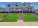 Inviting townhome with a well-manicured lawn and charming staircases leading to each front door at 4120 E 119Th Pl # B, Thornton, CO 80233