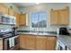 Efficient kitchen with stainless steel appliances, wooden cabinets and natural light at 4120 E 119Th Pl # B, Thornton, CO 80233