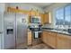 Well-equipped kitchen features stainless steel appliances, wood cabinets, and a window at 4120 E 119Th Pl # B, Thornton, CO 80233