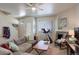 Comfortable living room featuring a cozy fireplace, large sectional sofa, and a ceiling fan at 4120 E 119Th Pl # B, Thornton, CO 80233