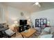 Relaxing living room with a fireplace, a cozy sectional, and a ceiling fan for comfort at 4120 E 119Th Pl # B, Thornton, CO 80233