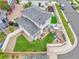 Aerial view of fenced backyard, patio with outdoor seating, and well-manicured lawn at 5131 Andes St, Denver, CO 80249
