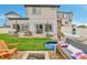 Cozy backyard features an artificial lawn, a patio, a fire pit, a hammock, and a seating area at 5131 Andes St, Denver, CO 80249