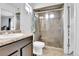 Bathroom with tile shower and glass doors, tile flooring and single sink at 5131 Andes St, Denver, CO 80249