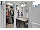 Bright bathroom with a walk-in closet, dark vanity, and ample counter space at 5131 Andes St, Denver, CO 80249