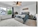 Bright bedroom with a gray bed frame, a ceiling fan, a window, and gray dressers at 5131 Andes St, Denver, CO 80249