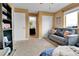 Bedroom featuring a double closet, neutral carpet and wall paint and a sofa at 5131 Andes St, Denver, CO 80249