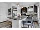 Modern kitchen with stainless steel appliances, granite countertops, and large island at 5131 Andes St, Denver, CO 80249