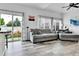 Cozy living room with sliding glass doors to the backyard and gray couches at 5131 Andes St, Denver, CO 80249