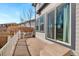 A cozy patio with white railings and a sliding door for easy indoor-outdoor living at 11010 Grayledge Cir, Highlands Ranch, CO 80130