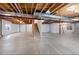 This basement has concrete floors and exposed ceiling beams and ductwork at 11010 Grayledge Cir, Highlands Ranch, CO 80130