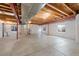 This basement has concrete floors and exposed ceiling beams at 11010 Grayledge Cir, Highlands Ranch, CO 80130