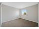 This bedroom features neutral paint, a large window, and carpeted floors at 11010 Grayledge Cir, Highlands Ranch, CO 80130