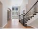 Bright entryway featuring hardwood floors, staircase, and views to the formal living area at 11010 Grayledge Cir, Highlands Ranch, CO 80130