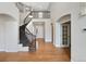 Open entryway features hardwood floors and a gracefully curved staircase at 11010 Grayledge Cir, Highlands Ranch, CO 80130