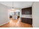 Kitchen featuring dark wood cabinets, tile backsplash, hardwood floors, and modern pendant lighting at 11010 Grayledge Cir, Highlands Ranch, CO 80130