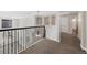 Upstairs landing with an ornate black railing, carpet, and view of downstairs at 11010 Grayledge Cir, Highlands Ranch, CO 80130