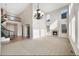 Bright, open-concept living room with soaring ceilings, fireplace, and elegant chandelier at 11010 Grayledge Cir, Highlands Ranch, CO 80130