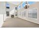 Bright and airy living room featuring a fireplace, large windows, and a modern chandelier at 11010 Grayledge Cir, Highlands Ranch, CO 80130