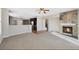 Open concept living room with stone fireplace next to an eat in kitchen at 11010 Grayledge Cir, Highlands Ranch, CO 80130