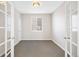 Carpeted office space featuring French doors and natural light from window at 11010 Grayledge Cir, Highlands Ranch, CO 80130