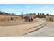 Community playground with swings, slides, and a soft surface for safe play at 11010 Grayledge Cir, Highlands Ranch, CO 80130